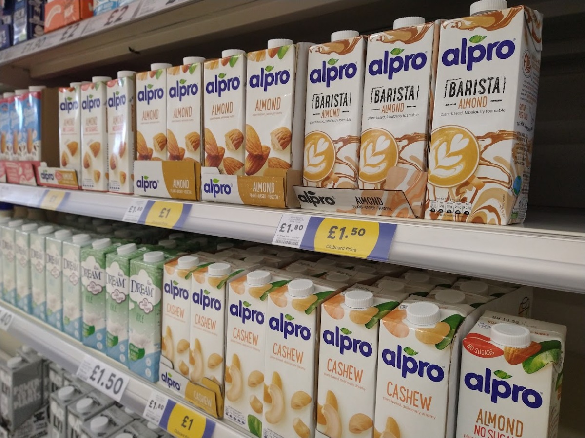 The alternative milks section in Tesco, with several shelves of Alpro and Rice dream.